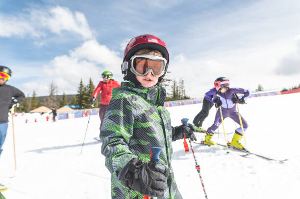 istock Elementary-age boy snow skiing with his family 1168849280