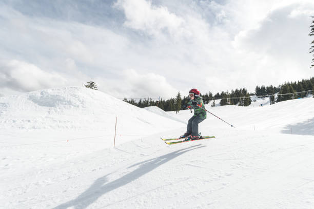 istock Young boy skiing down a snowy mountain 1168849287