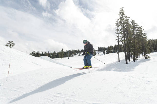 istock Male snow skiier jumping through the air 1168849288