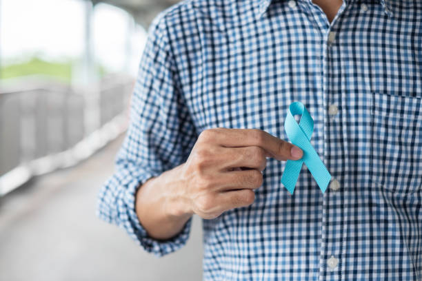 November Prostate Cancer Awareness month, Man in blue shirt with hand holding Blue Ribbon for supporting people living and illness. Healthcare, International men, Father and World cancer day concept November Prostate Cancer Awareness month, Man in blue shirt with hand holding Blue Ribbon for supporting people living and illness. Healthcare, International men, Father and World cancer day concept prostate gland stock pictures, royalty-free photos & images