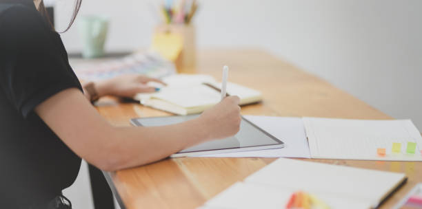 istock Close-up view of female graphic designer working on her project 1168856561