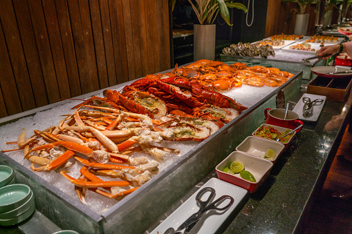 Pile of fresh lobsters and crabs at seafood buffet restaurant