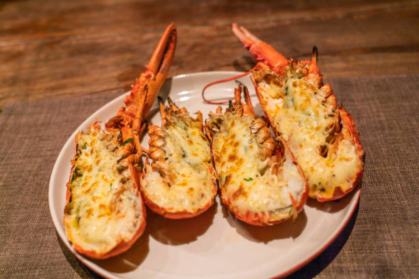 istock Delicious grilled lobsters and cheese on white plate 1168865259