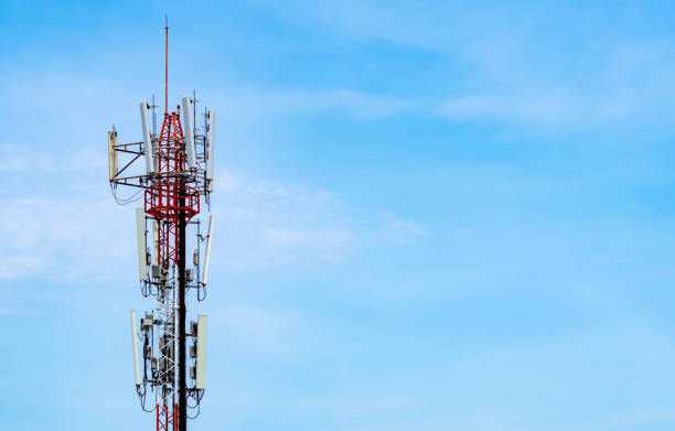 istock Telecommunication tower with blue sky and white clouds background. Antenna on blue sky. Radio and satellite pole. Communication technology. Telecommunication industry. Mobile or telecom 4g network. 1168865406