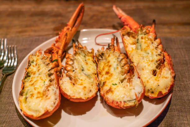 istock Hot and cheesy grilled lobsters on white plate 1168865476