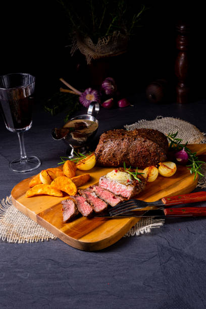 istock rustic medium butter beef steak with herbs and potato wedges 1168867838