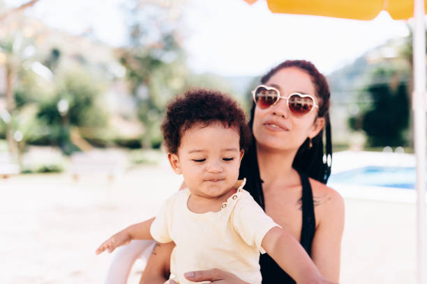 istock Affectionate young African descendant mother spending time outdoors with her baby son 1168867913