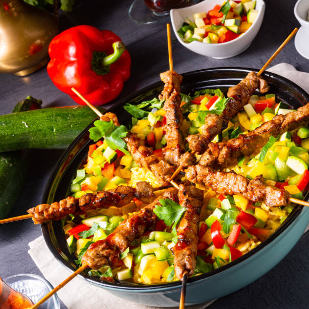 istock Lamb skewers with curry rice and different vegetables 1168867971