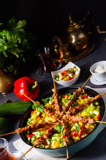 istock Lamb skewers with curry rice and different vegetables 1168867978