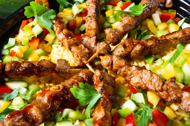 istock Lamb skewers with curry rice and different vegetables 1168867985