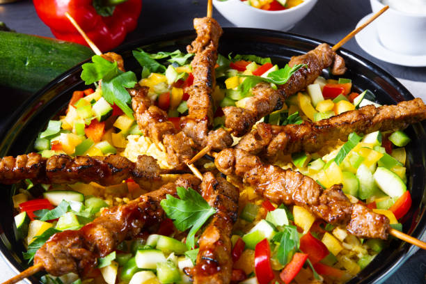 Lamb skewers with curry rice and different vegetables
