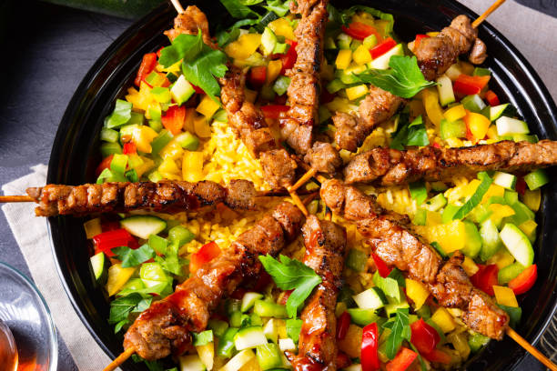 istock Lamb skewers with curry rice and different vegetables 1168868005