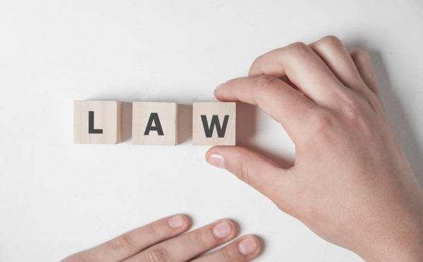 istock Hand holding wooden cube. Law concept 1168868021