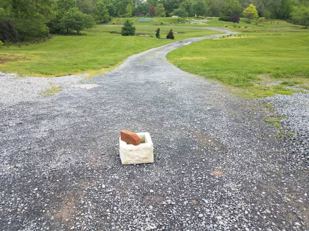 long gravel path with cinder block and brick long gravel path or trail with cinder block and brick and grass pebble driveway stock pictures, royalty-free photos & images