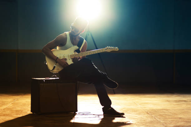 istock Young Afro American man playing electric guitar 1168869639