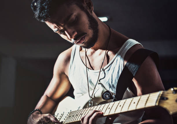istock Young Afro American man playing electric guitar 1168869640