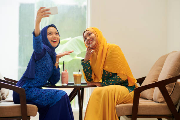 istock Muslim women photographing in cafe 1168869821
