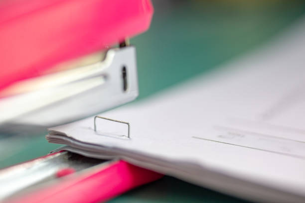 istock The pink stapler does not pierce through many sheets of paper.shallow focus effect. 1168872437