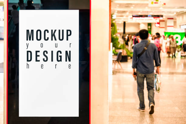 istock Mockup blank advertising billboard or advertising light box for your text message or media content inside building with blurred view of people background. Mock up billboard for commercial, marketing and financial concept. 1168872584
