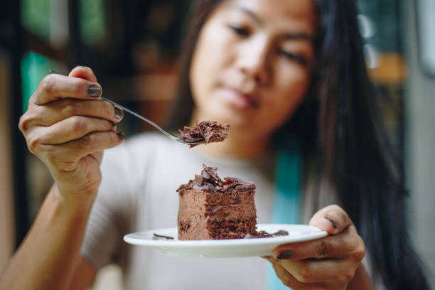 istock Asian woman eating chocolate cake at cafe 1168872713
