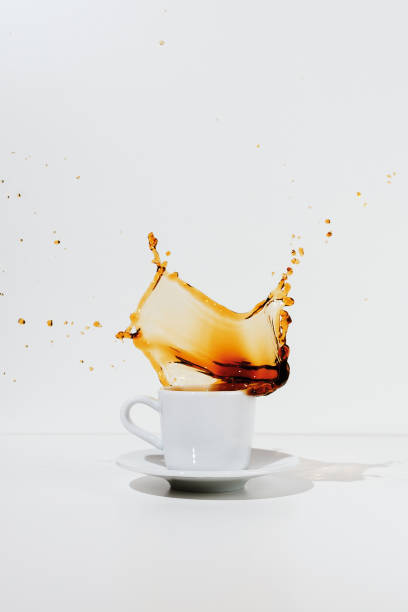 istock White cup and saucer with splashing coffee 1168872736