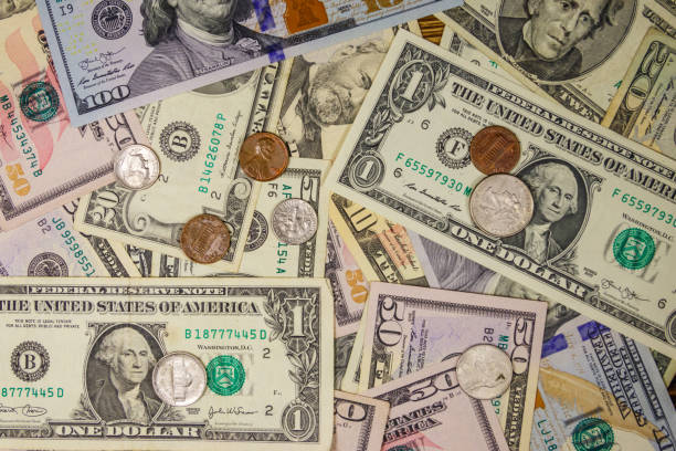 istock Background of different american dollars bills and coins 1168873544