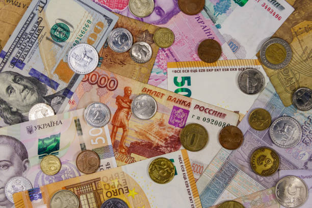 istock Background of banknotes and coins from different countries 1168873609