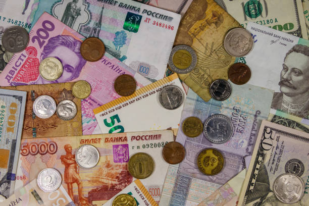 istock Background of banknotes and coins from different countries 1168873611
