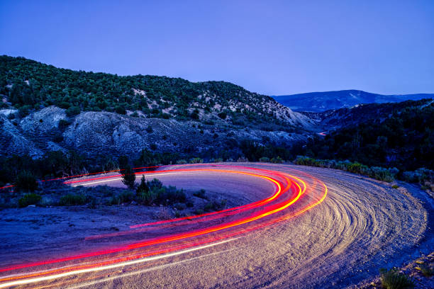istock Scenic Dirt Road Driving at Night Time Exposure 1168874468