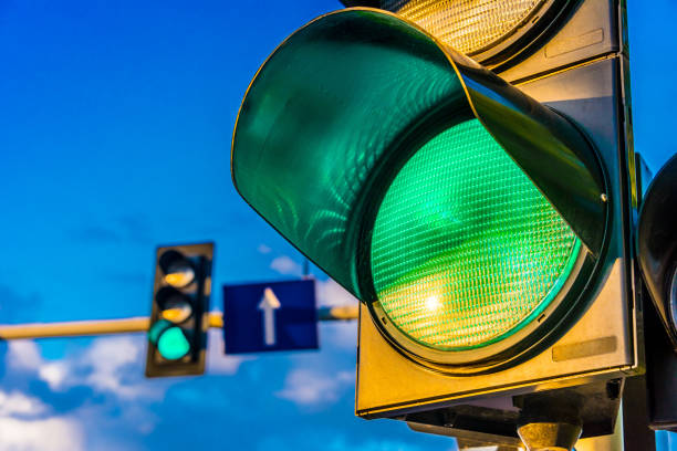 Traffic lights over urban intersection Traffic lights over urban intersection. Green light green light stoplight stock pictures, royalty-free photos & images