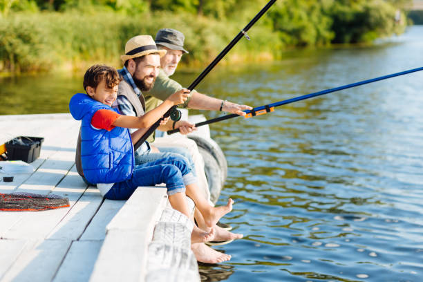 istock Men of three generations feeling happy while fishing in summer 1168883595