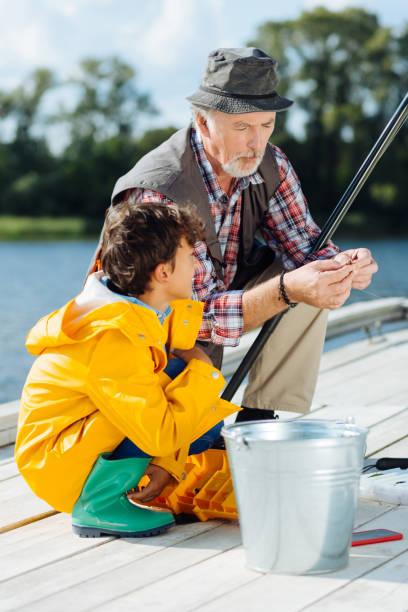 istock Elder man telling grandson everything about fishing 1168883906