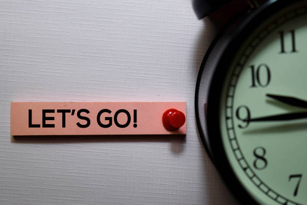 Let's Go! text on sticky notes isolated on office desk