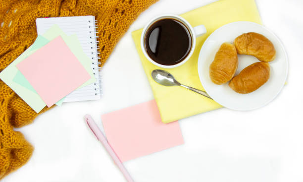 istock Breakfast in bed. Flat composition with coffee, croissants and a notebook for writing. Lifestyle concept frame. Top view on sheets 1168889188