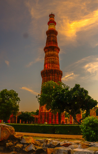 The qutub tower stand glowing with evening golden hour