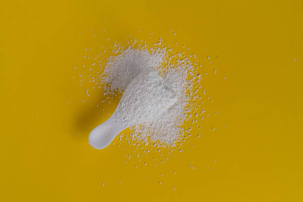 istock little scoop with washing powder detergent on the yellow surface 1168890526