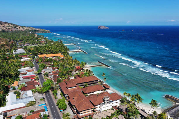 Beautiful drone view of resorts and white sand beach at Candi Dasa, East Bali.