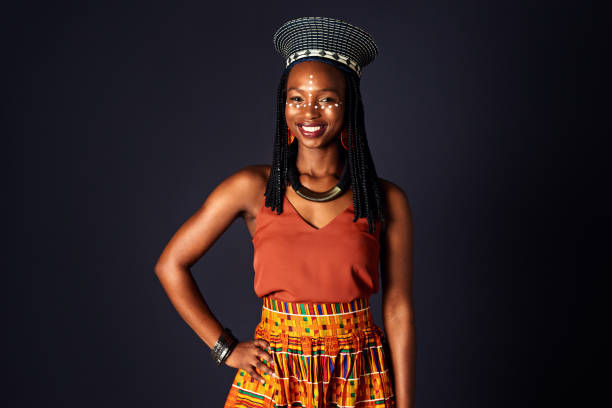 What I wear is part of where I come from Studio shot of an attractive young woman dressed in traditional african attire posing against a black background african tribe stock pictures, royalty-free photos & images