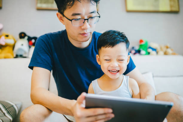 istock Asian father and son using digital table at home. 1168891591