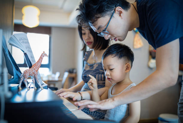 istock Chinese parents teaching her son how to play piano. 1168891602