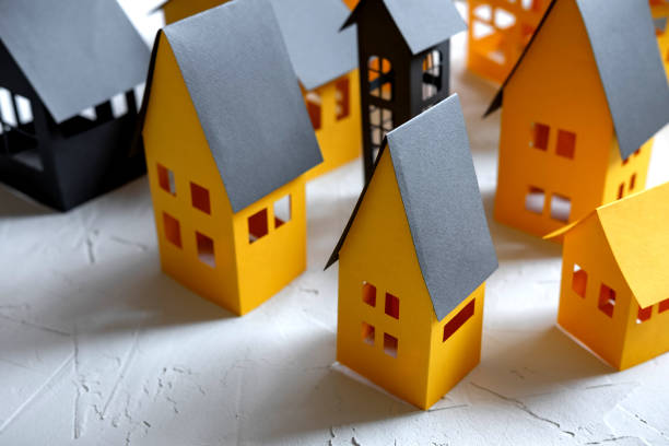 istock Paper City cut from a yellow paper on white background 1168891834