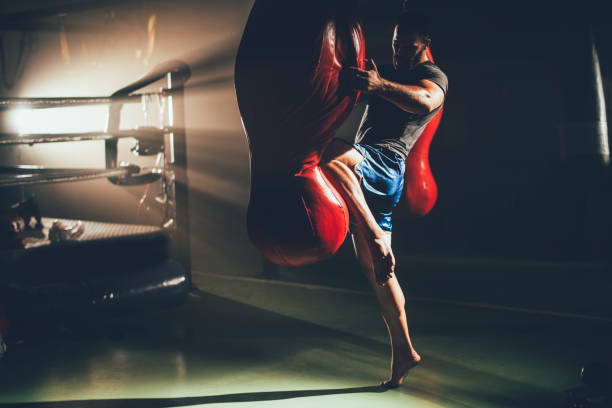 istock Boxer at training in the ring punching bag 1168891926