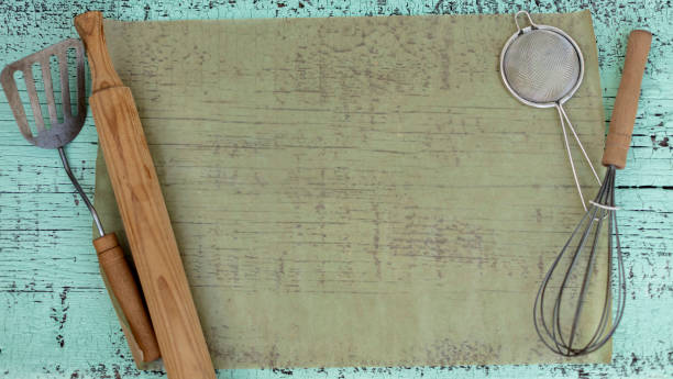 istock Vintage old kitchen utensils on a green wooden background. 1168892858
