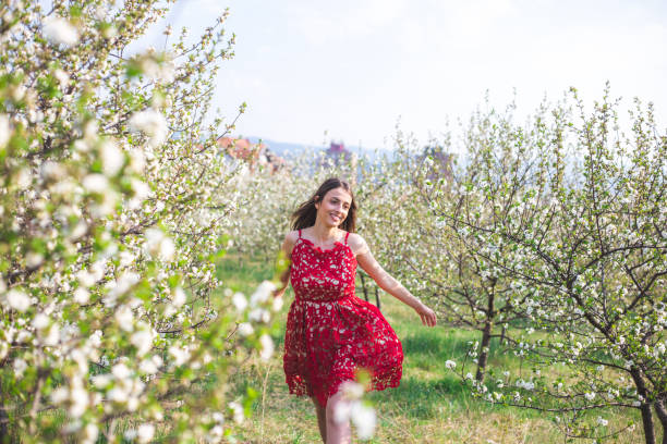 istock Young woman among blooming trees 1168893722