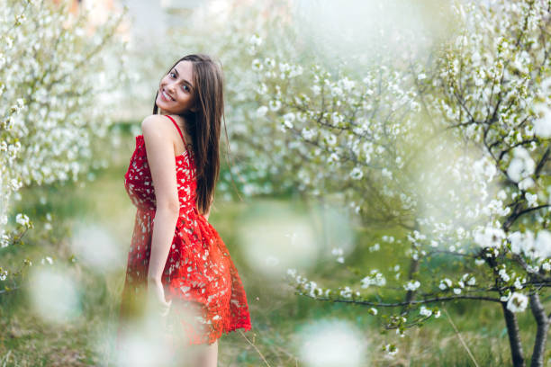 istock Young woman among blooming trees 1168893728