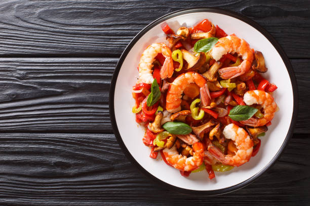 Fragmnet of shrimp salad with mushrooms. Isolated in a white background. Close-up.