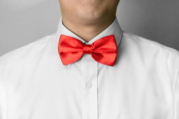 Man ties a red bowtie at the collar Man ties a red bowtie at the collar necktie businessman collar tied knot stock pictures, royalty-free photos & images