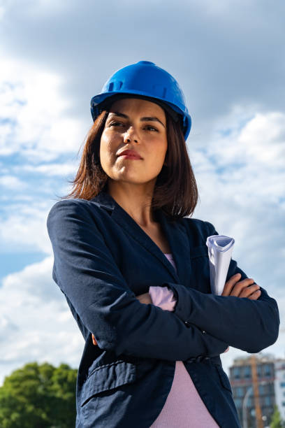 istock Charming and successful woman architect posing with folded arms. Low-angle shot 1168896641