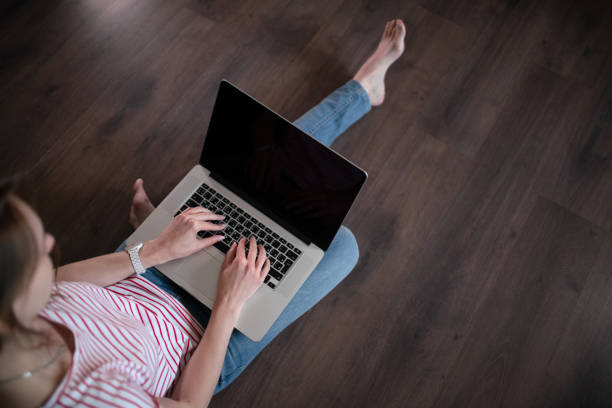 istock Woman surfs the web on a laptop at home 1168896735