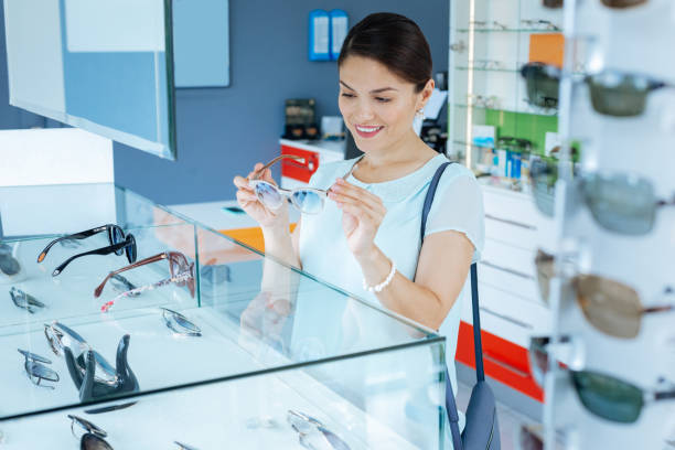 istock Pleasant cheerful woman looking at the eyeglasses 1168896801